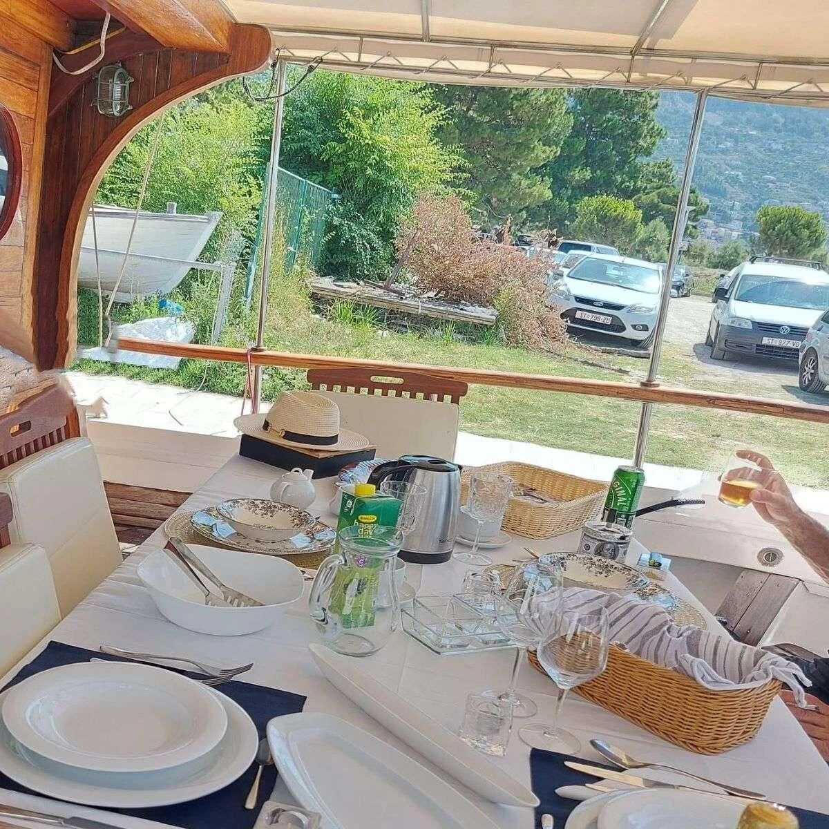 a table with plates and glasses aboard W Yacht for Sale
