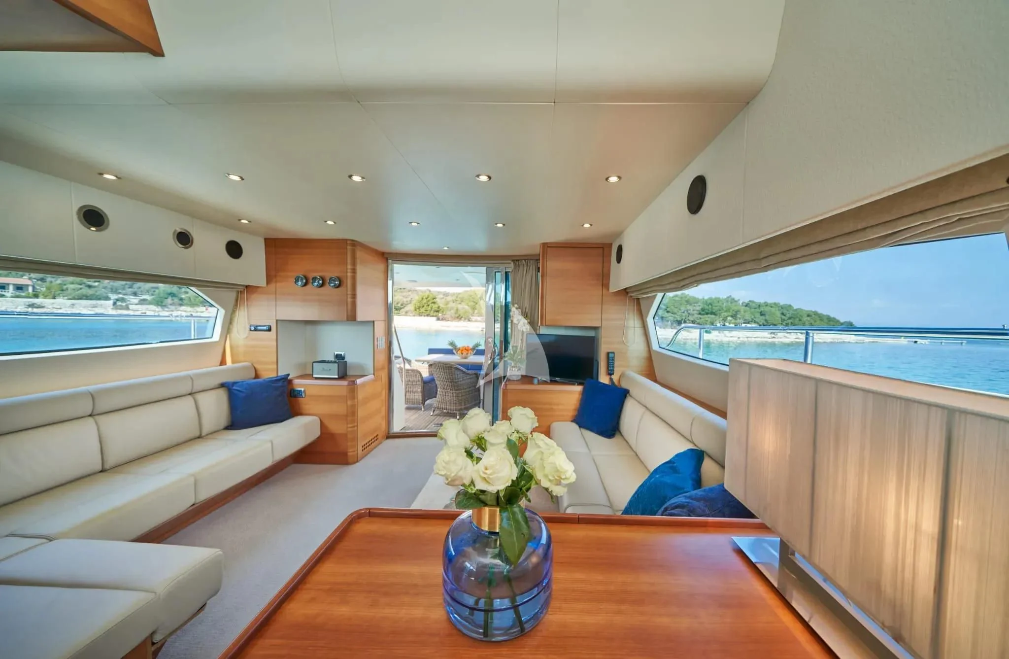 a living room with a vase of flowers on a table aboard W Yacht for Sale