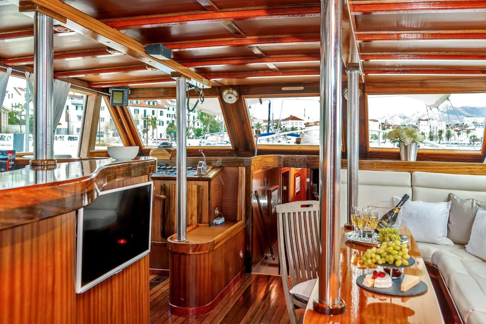 a room with a tv and furniture aboard W Yacht for Sale