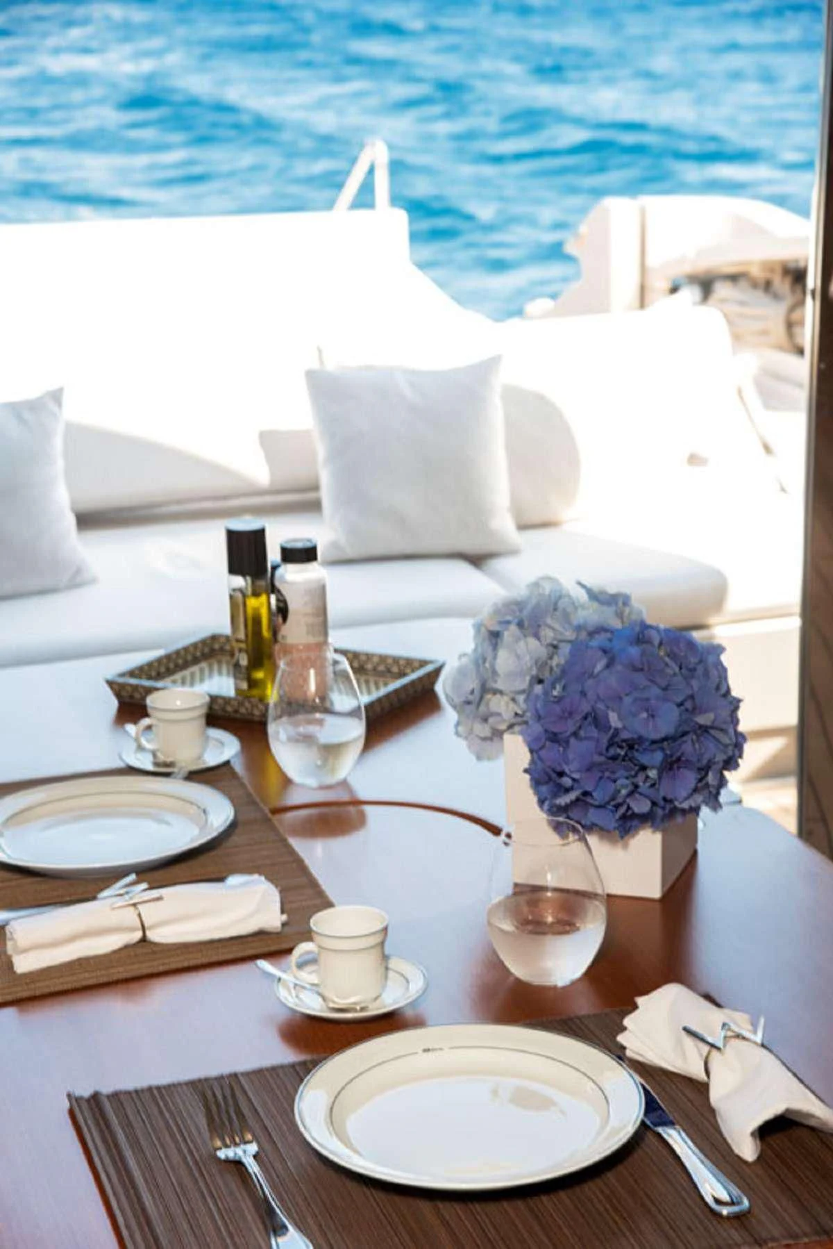 a table with plates and flowers aboard W Yacht for Sale