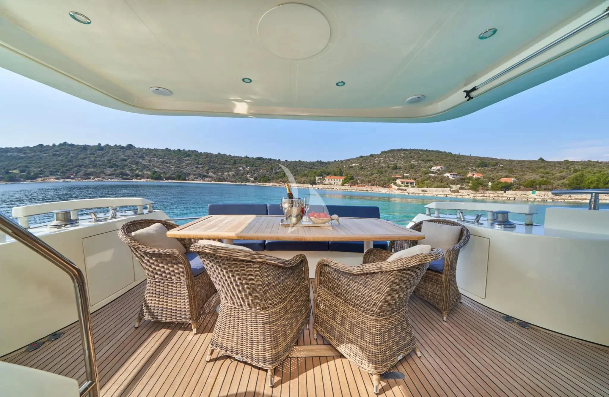 a table and chairs on a deck overlooking a body of water aboard W Yacht for Sale