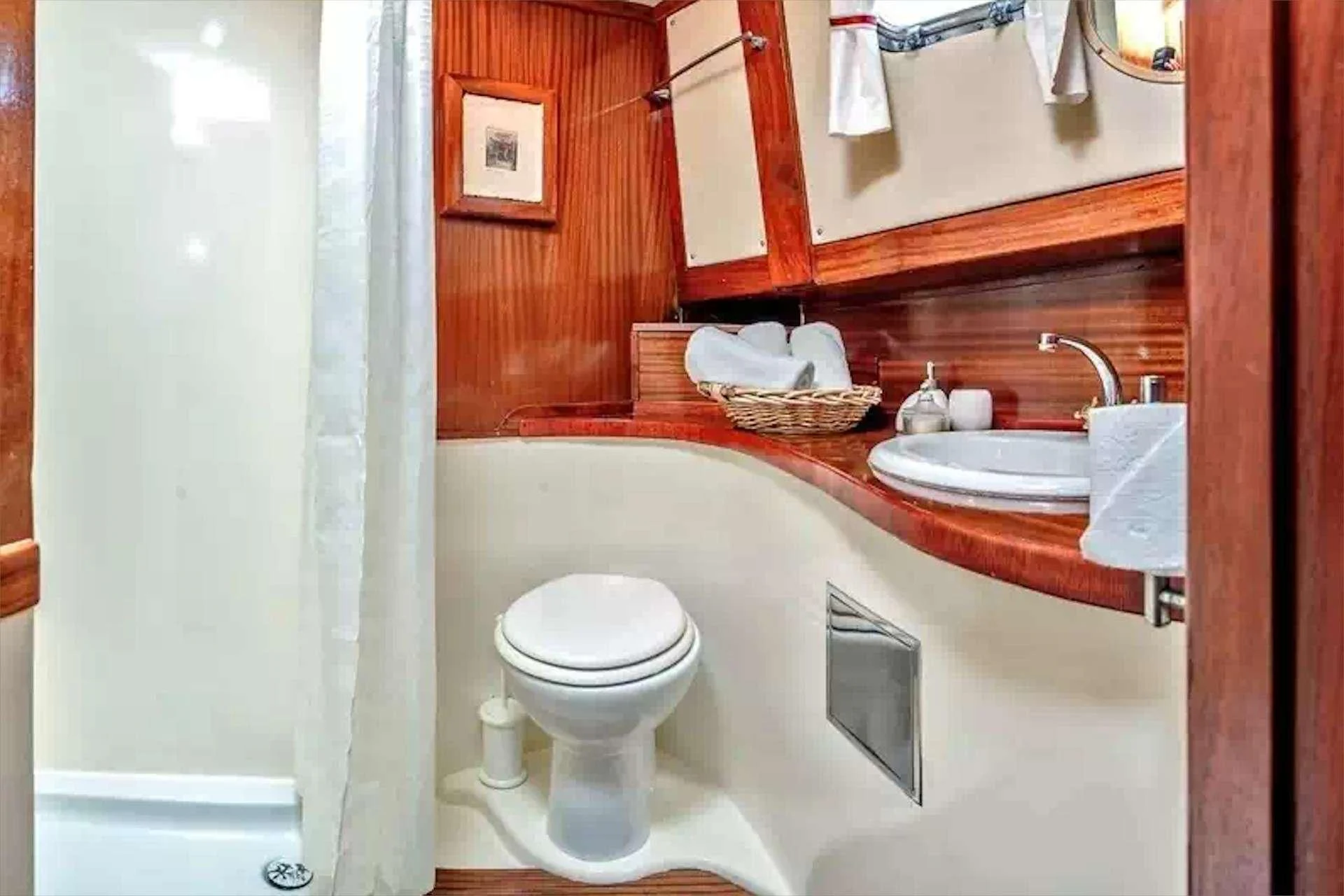 a bathroom with a sink toilet and a mirror aboard W Yacht for Sale