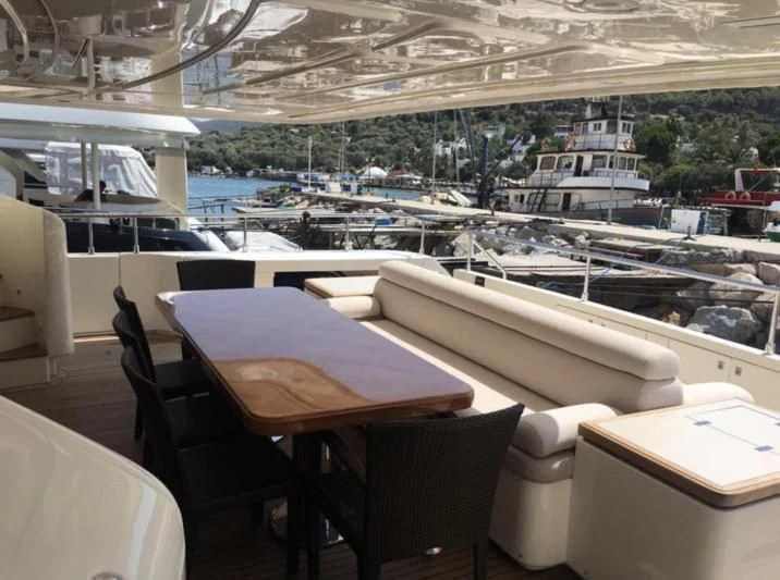 a room with tables and chairs aboard CEYLANIM Yacht for Sale