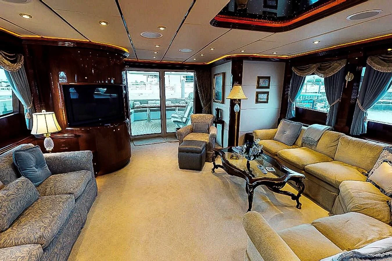 a living room with a large window aboard IDLETYME II Yacht for Sale