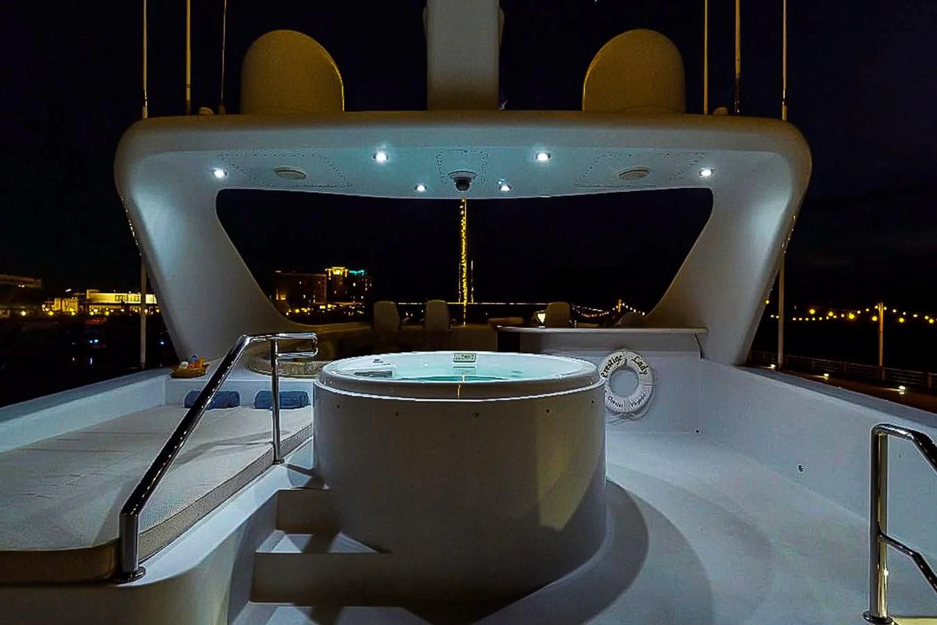 a large outdoor bar with a large round table and chairs aboard IDLETYME II Yacht for Sale
