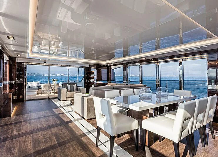a room with tables and chairs aboard THETIS Yacht for Sale