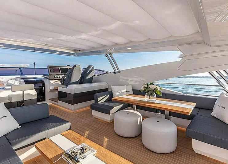 a room with a table chairs and a pool aboard THETIS Yacht for Sale