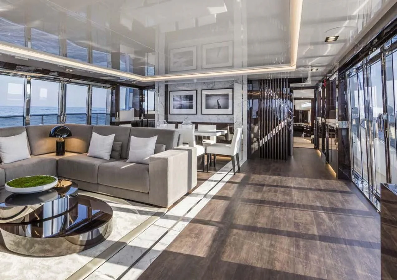 a large living room with a wood floor aboard THETIS Yacht for Sale