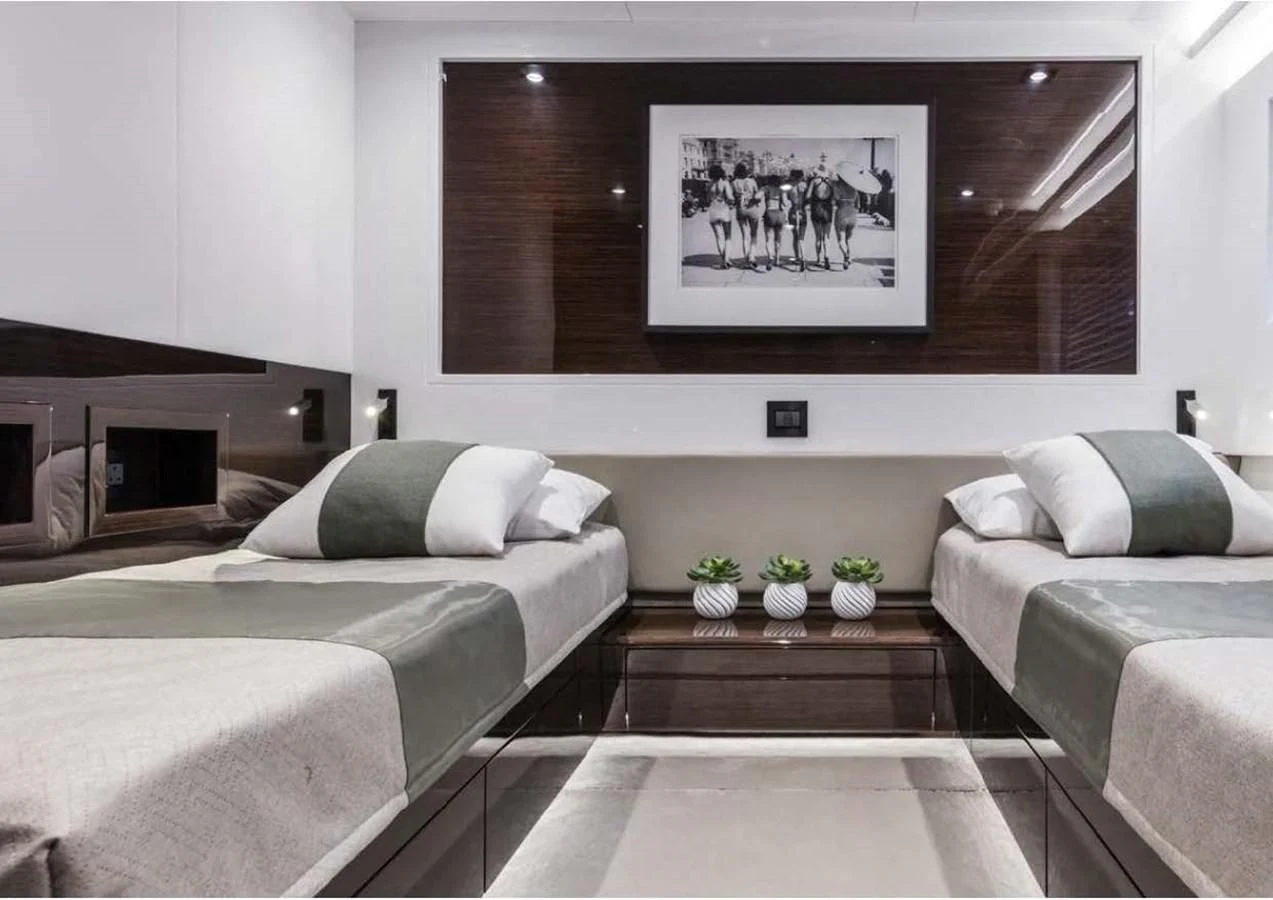 a room with a bed and a couch aboard THETIS Yacht for Sale