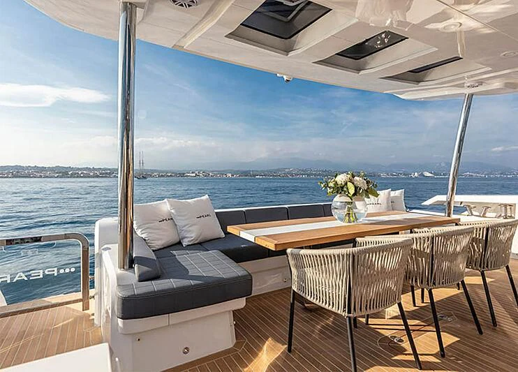 a patio with a table and chairs aboard THETIS Yacht for Sale