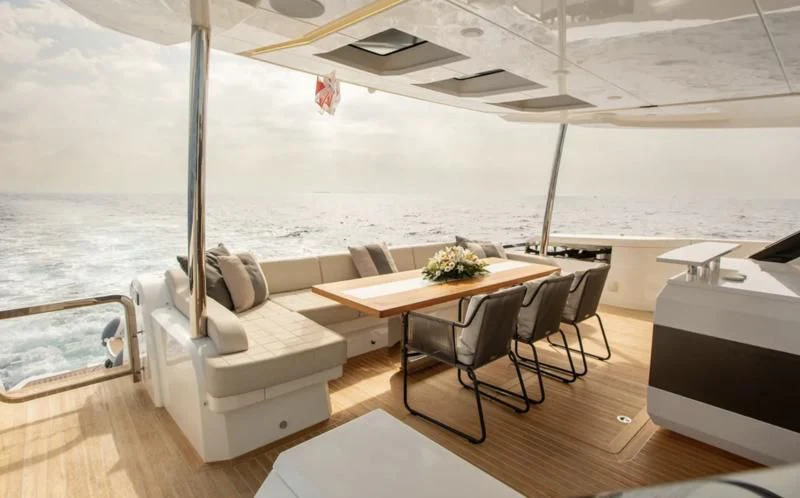 a room with a table and chairs aboard THETIS Yacht for Sale