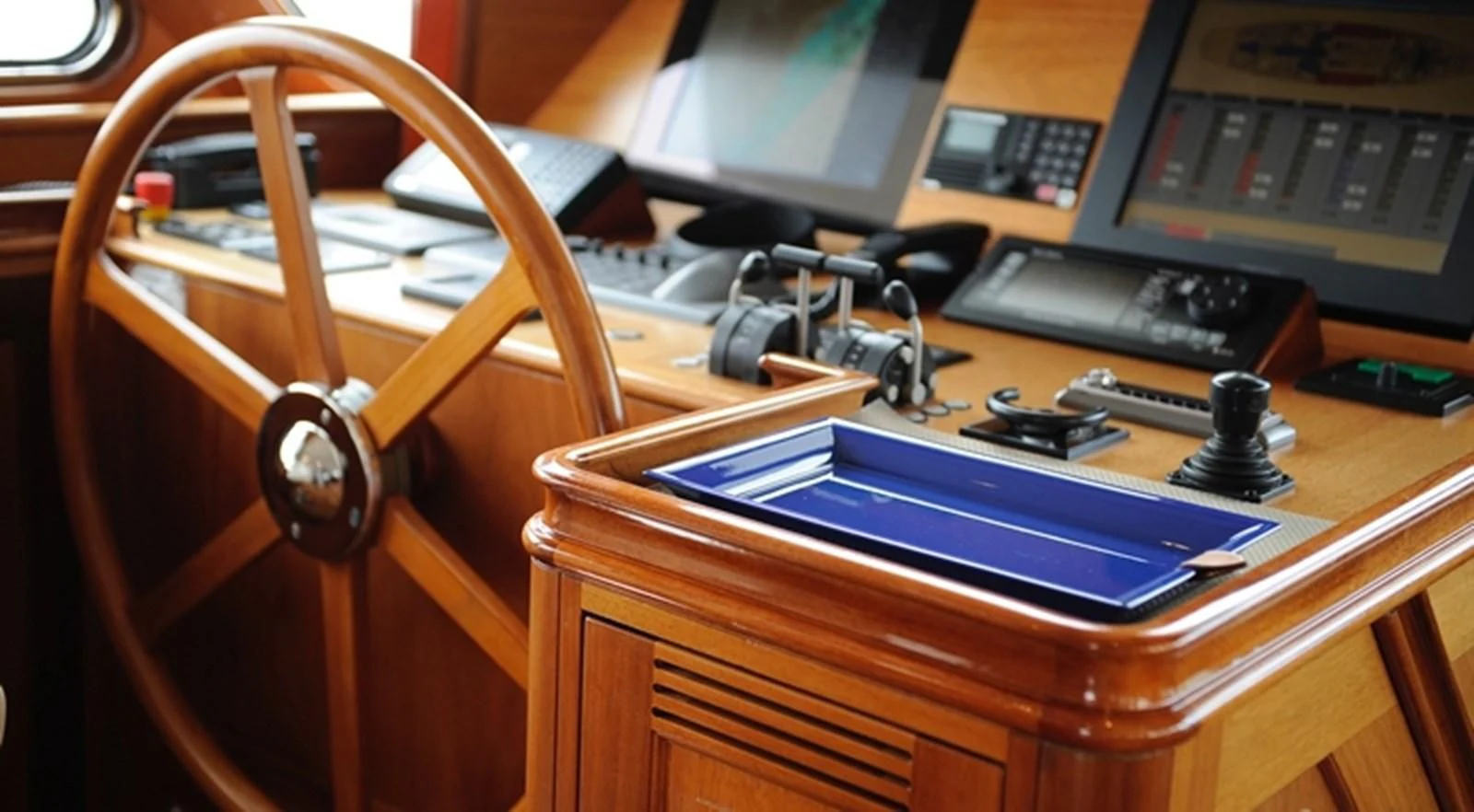 a wooden desk with a laptop and a camera on it aboard AVENTURA Yacht for Sale