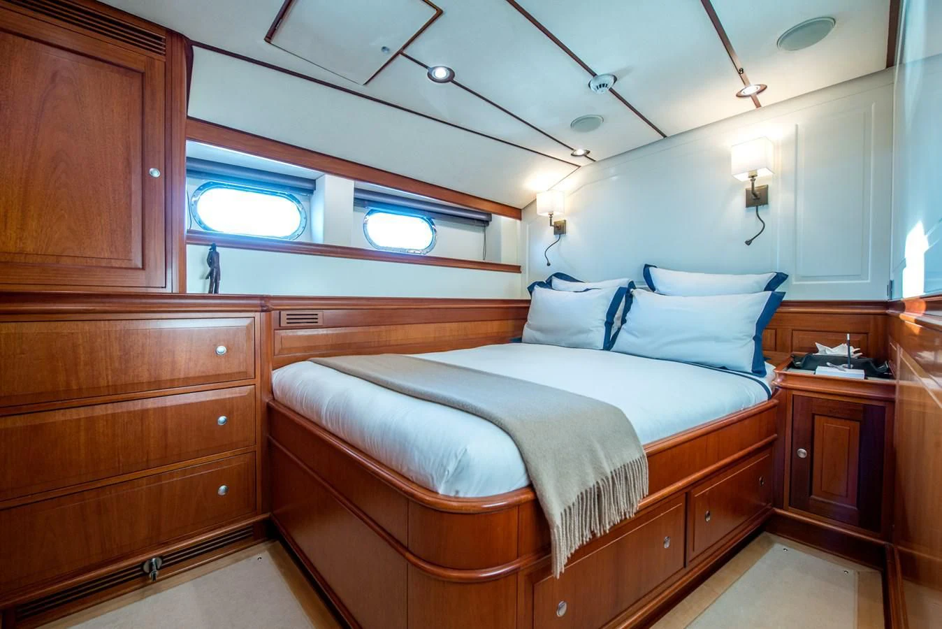 a bedroom with a bed and a desk aboard AVENTURA Yacht for Sale