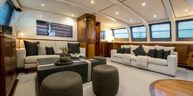 a living room with a couch and a table aboard AVENTURA Yacht for Sale
