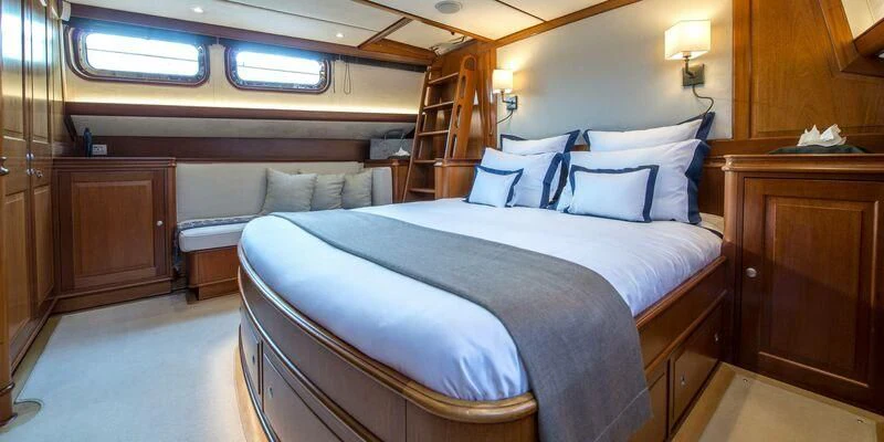 a room with a bed and a staircase aboard AVENTURA Yacht for Sale