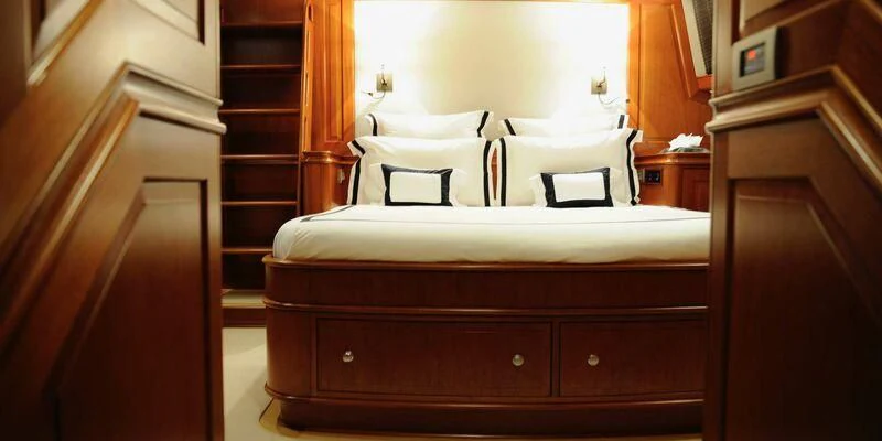 a bed with white sheets aboard AVENTURA Yacht for Sale