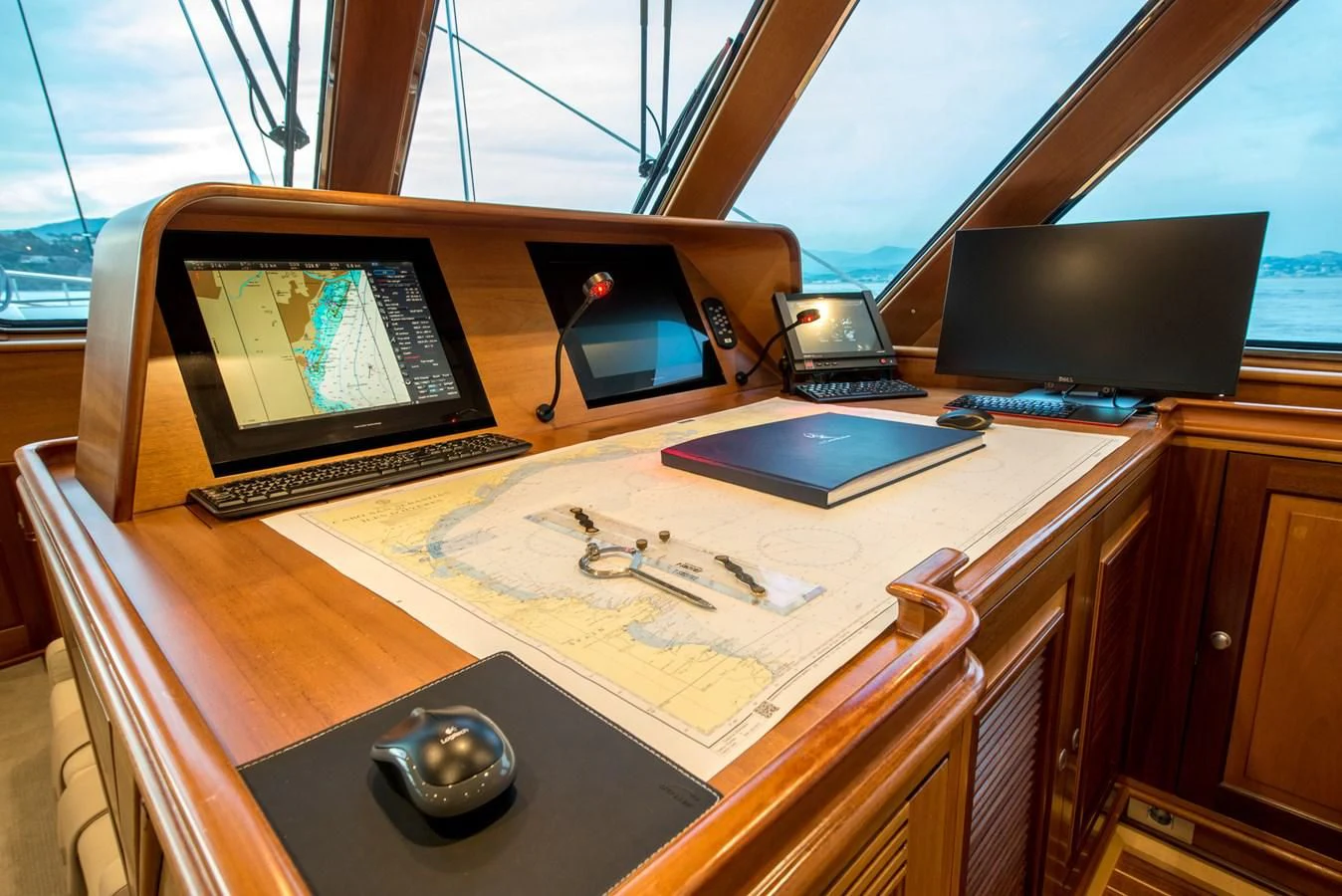 a desk with laptops and other electronics on it aboard AVENTURA Yacht for Sale