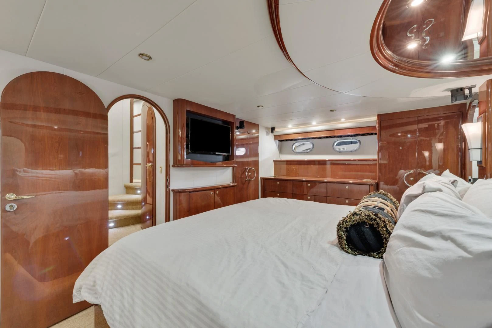a bedroom with a bed and a television aboard CLEW LESS Yacht for Sale