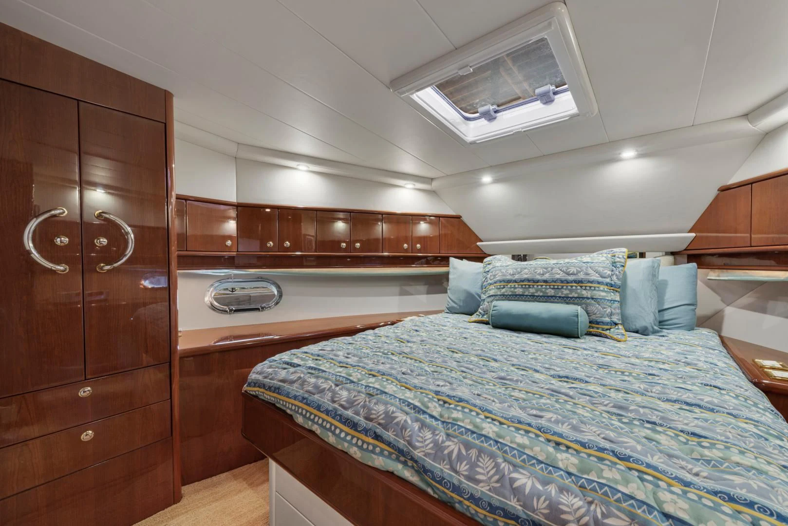 a room with a bed and a wooden cabinet aboard CLEW LESS Yacht for Sale