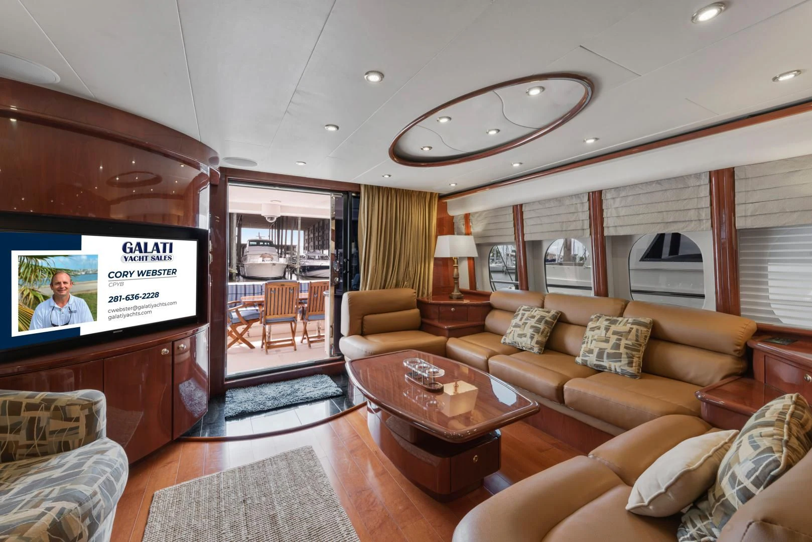 a living room with a large screen aboard CLEW LESS Yacht for Sale