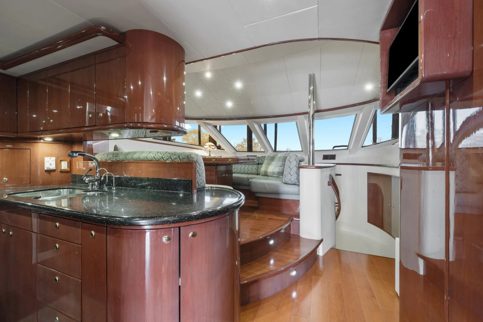 a kitchen with a sink and a couch aboard CLEW LESS Yacht for Sale