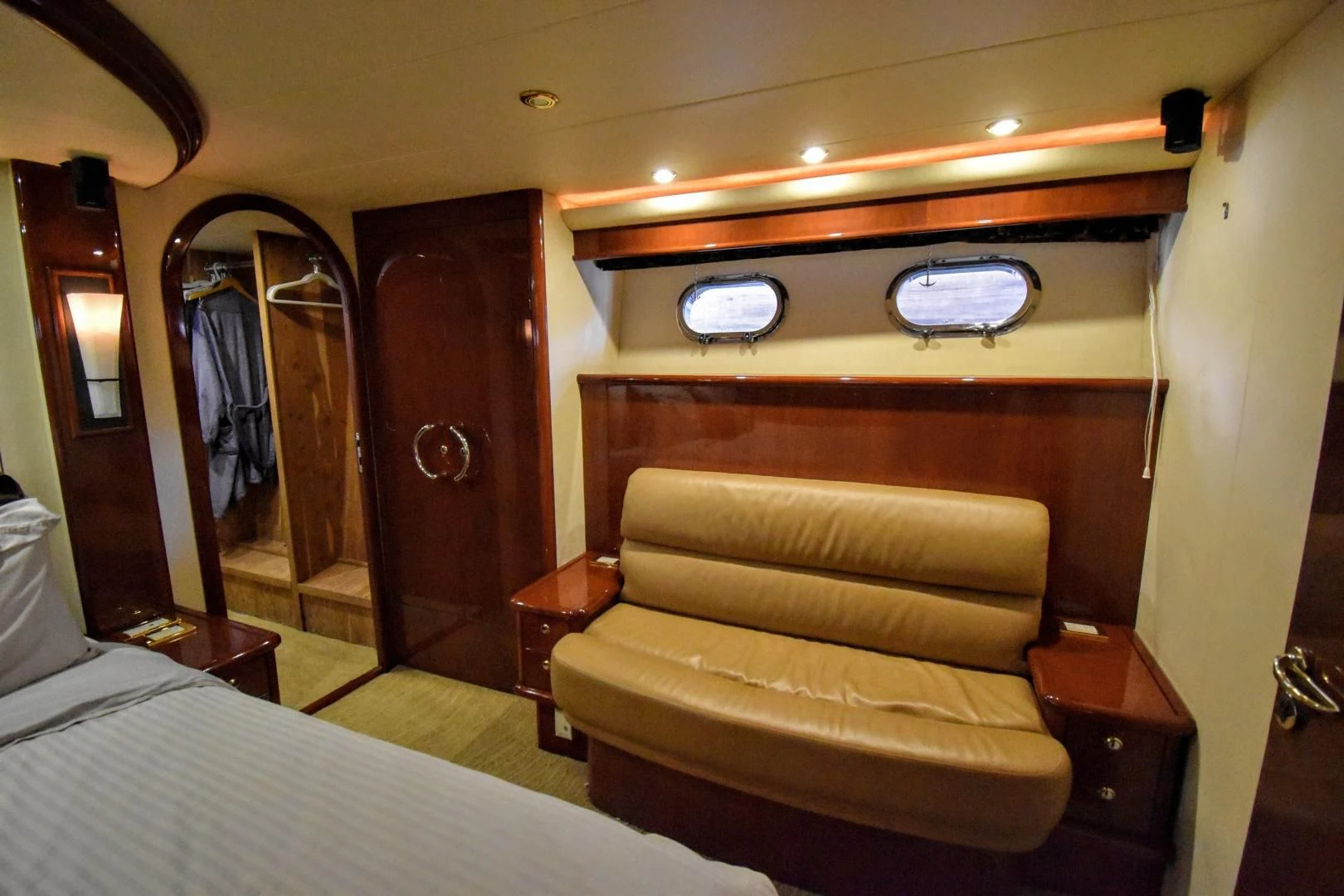 a room with a couch and a mirror aboard CLEW LESS Yacht for Sale