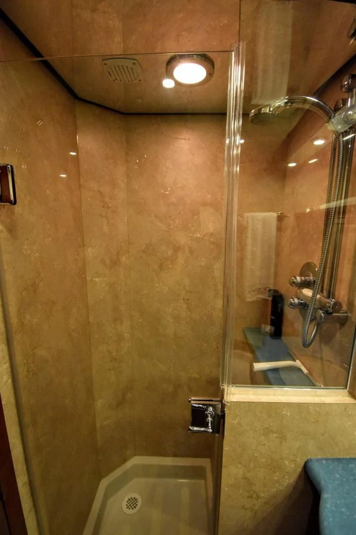 a bathroom with a glass shower aboard CLEW LESS Yacht for Sale
