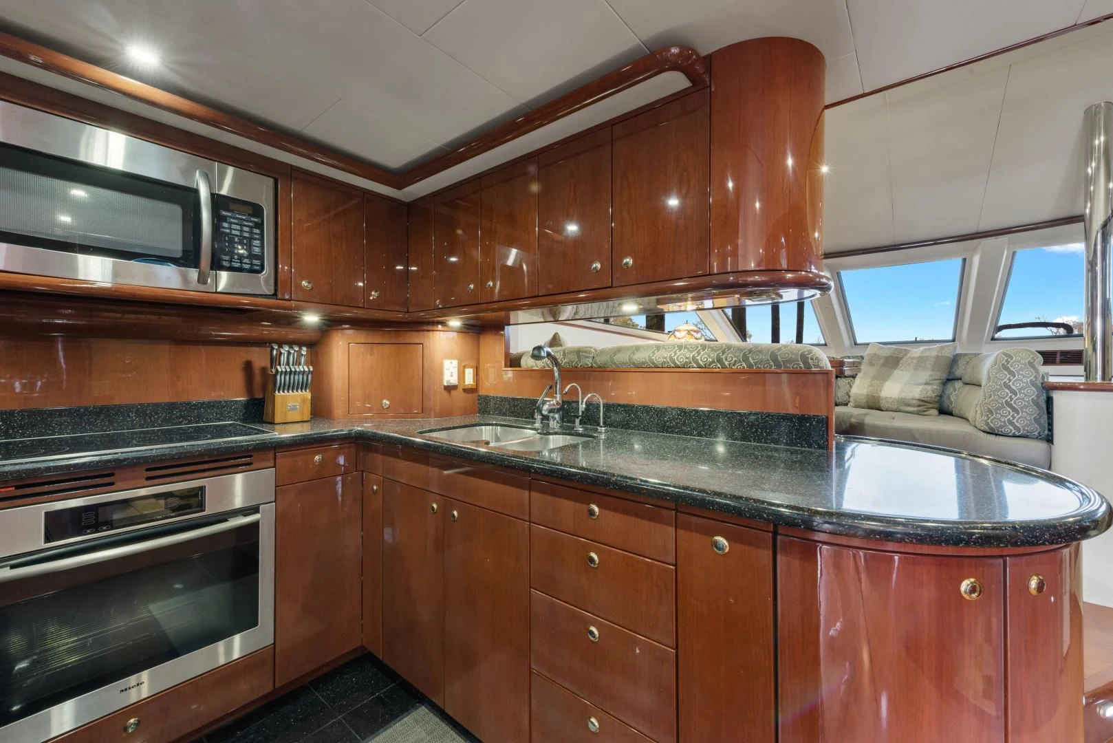 a kitchen with wooden cabinets aboard CLEW LESS Yacht for Sale