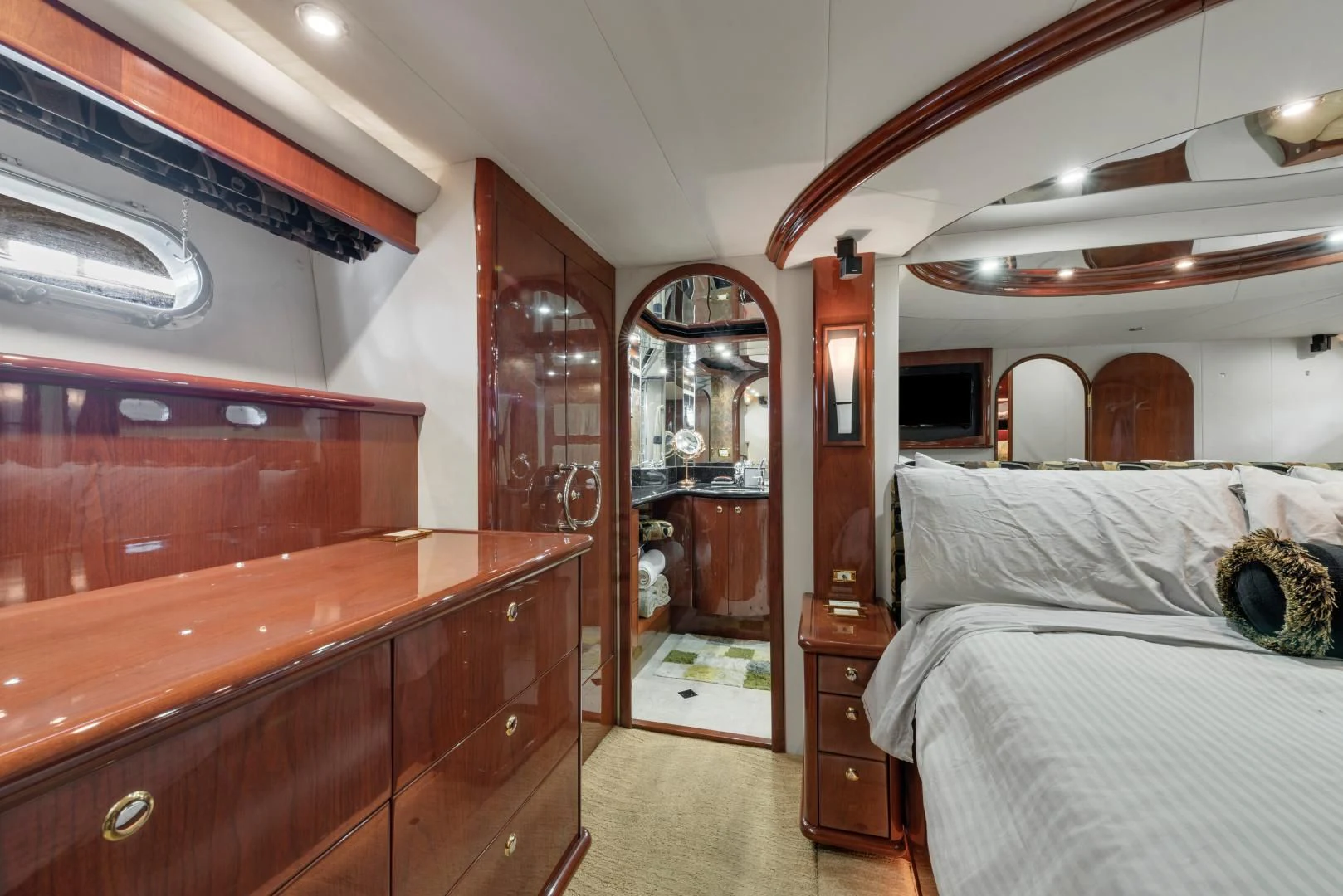 a bedroom with a bed and a mirror aboard CLEW LESS Yacht for Sale