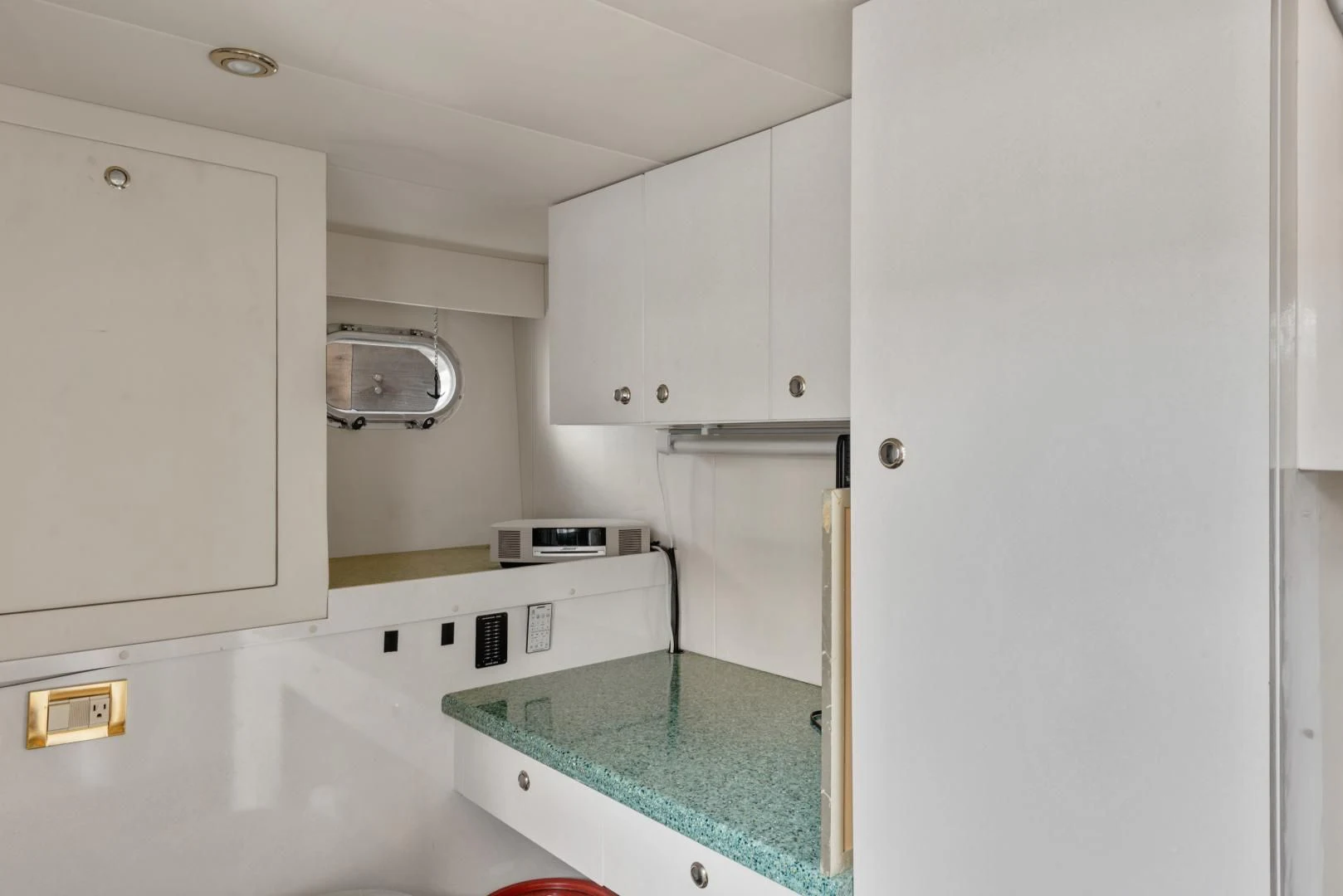 a kitchen with white cabinets aboard CLEW LESS Yacht for Sale