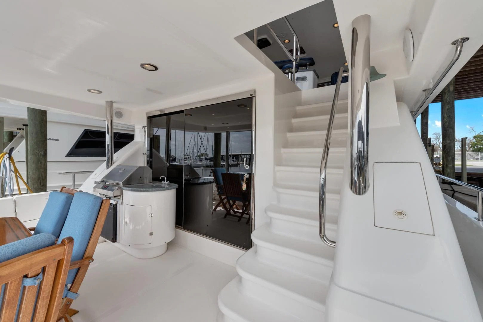 a white kitchen with a staircase aboard CLEW LESS Yacht for Sale