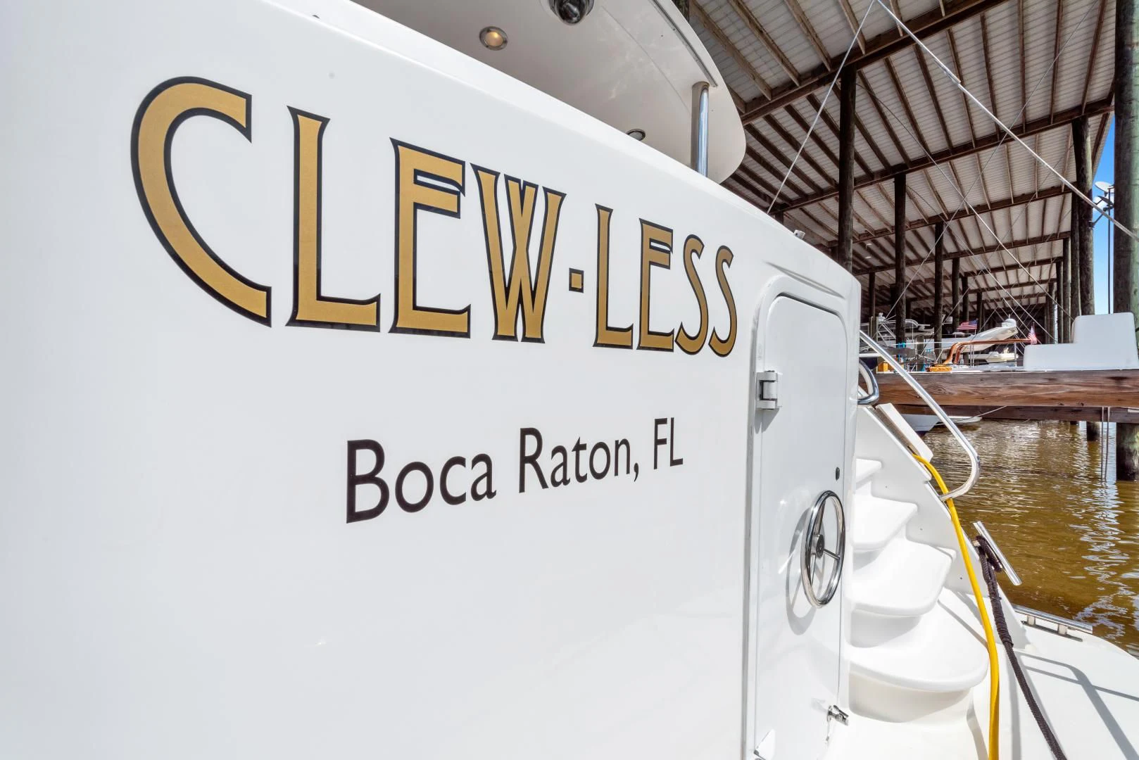 a white sign with black text on it aboard CLEW LESS Yacht for Sale