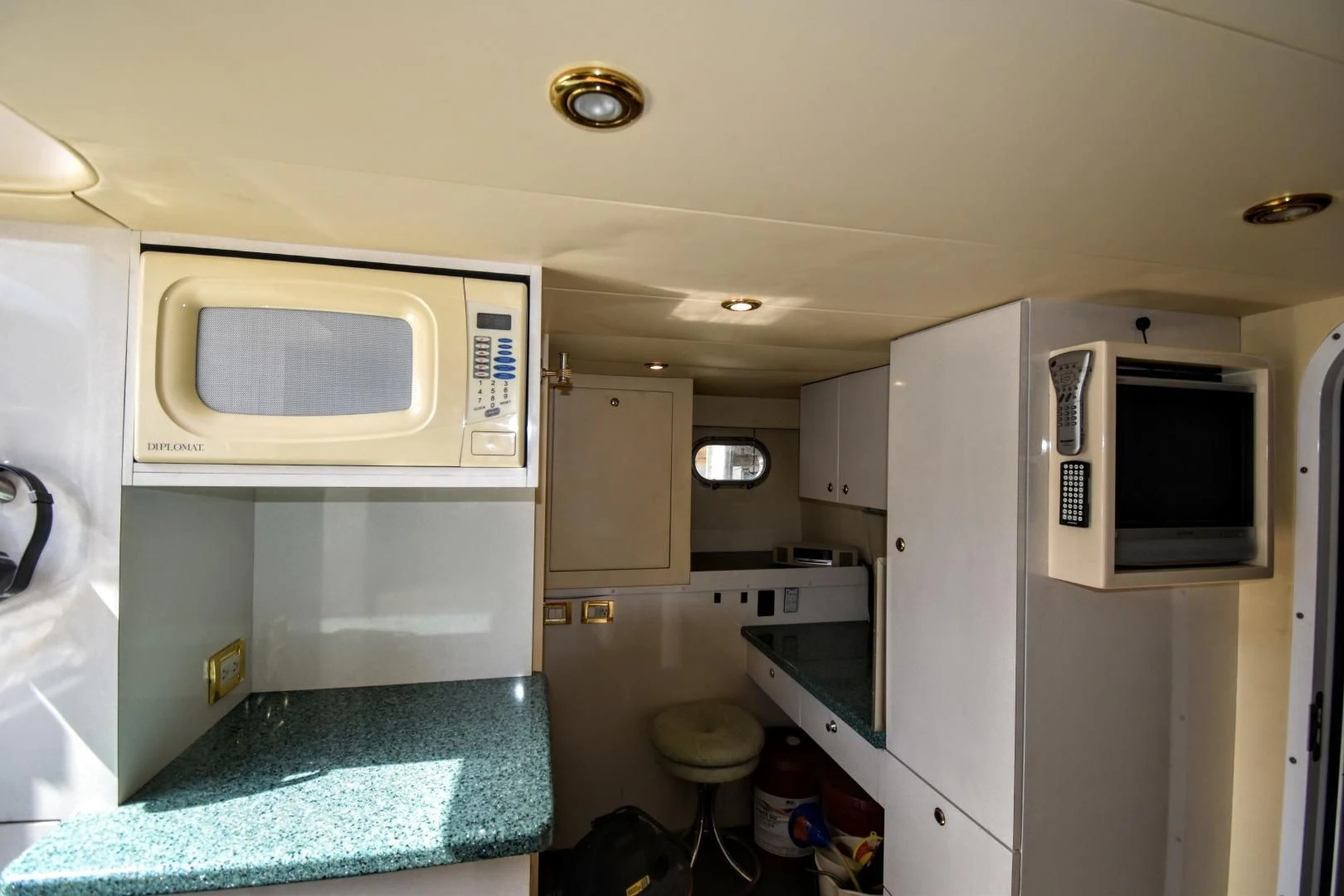 a small kitchen with a microwave oven aboard CLEW LESS Yacht for Sale
