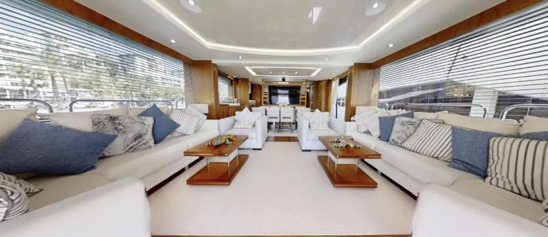 a large room with white couches and a table aboard LUCKY GIRLS Yacht for Sale