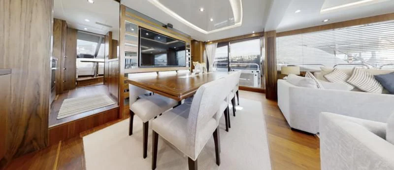 a room with a table chairs and a bed aboard LUCKY GIRLS Yacht for Sale