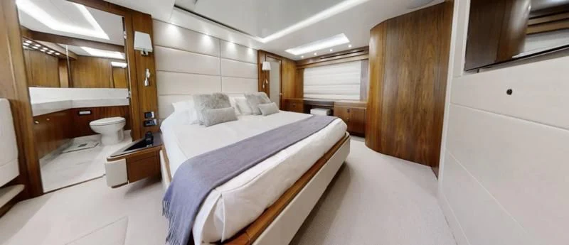 a room with a bed and a wood cabinet aboard LUCKY GIRLS Yacht for Sale