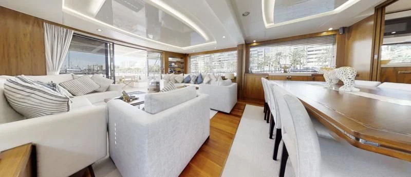 a large room with a table and chairs aboard LUCKY GIRLS Yacht for Sale