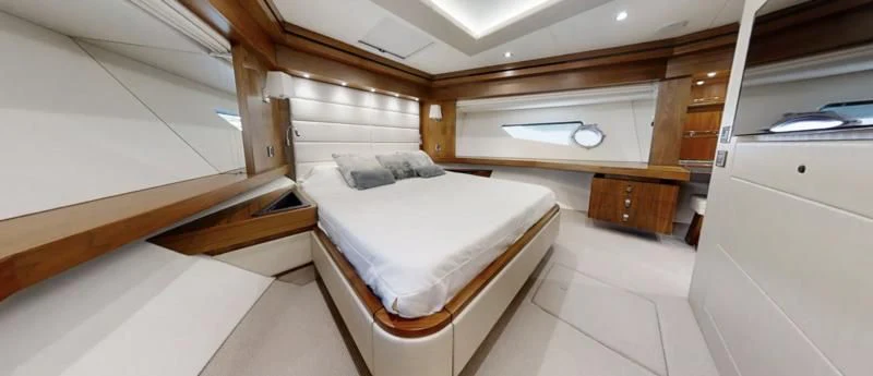 a room with a bed and a desk aboard LUCKY GIRLS Yacht for Sale