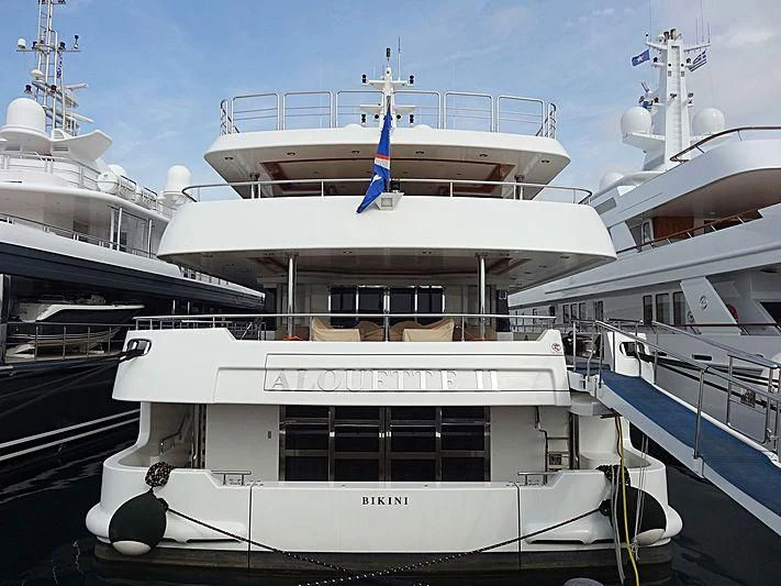 a large white boat with a blue stripe on the front aboard ALOUETTE II Yacht for Sale
