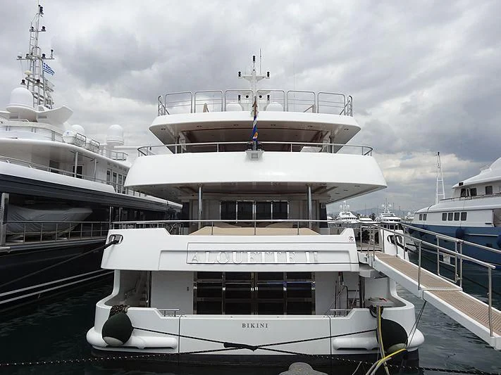 a large white boat in a harbor aboard ALOUETTE II Yacht for Sale