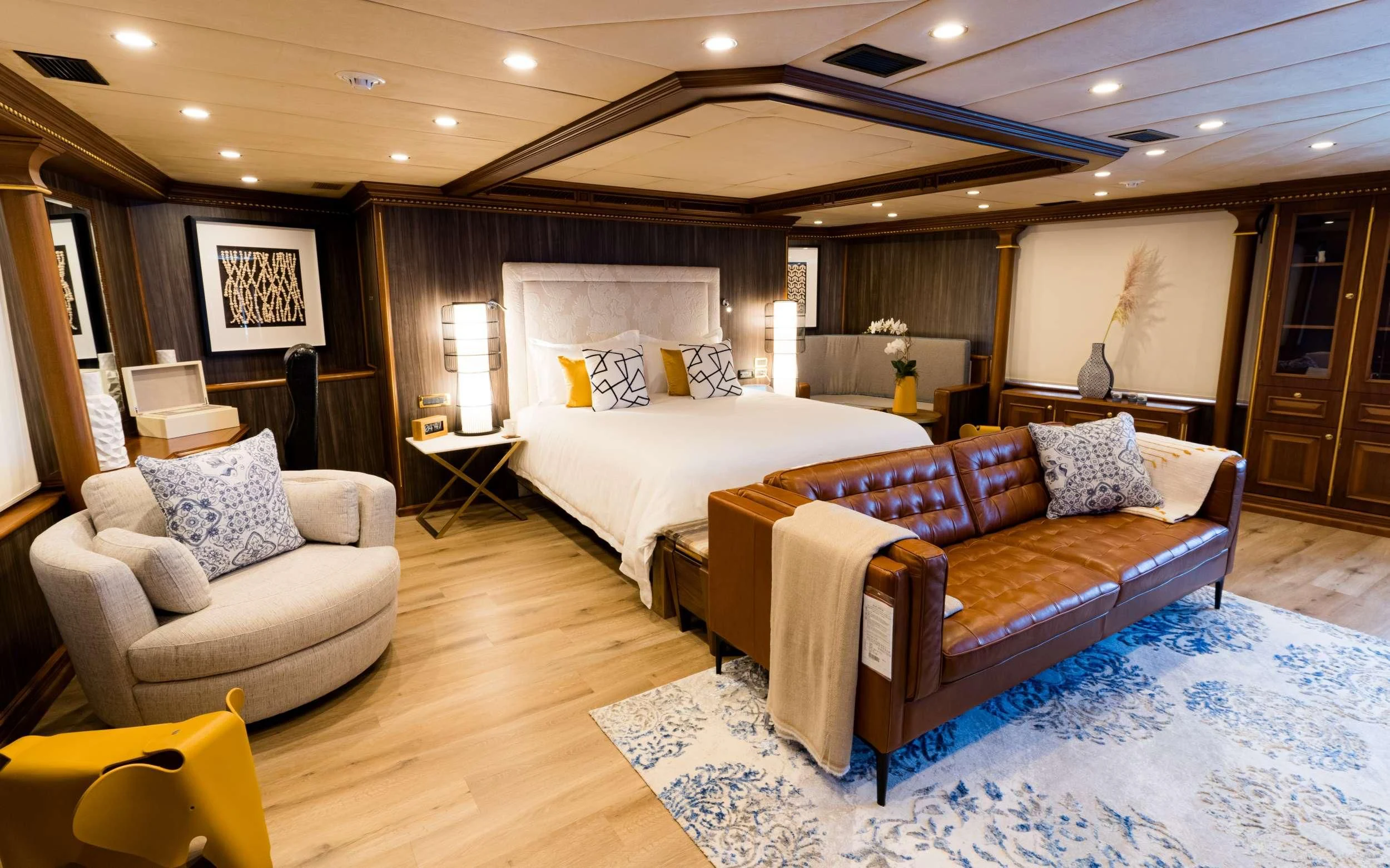 a room with a bed and a couch aboard IRAMA Yacht for Sale