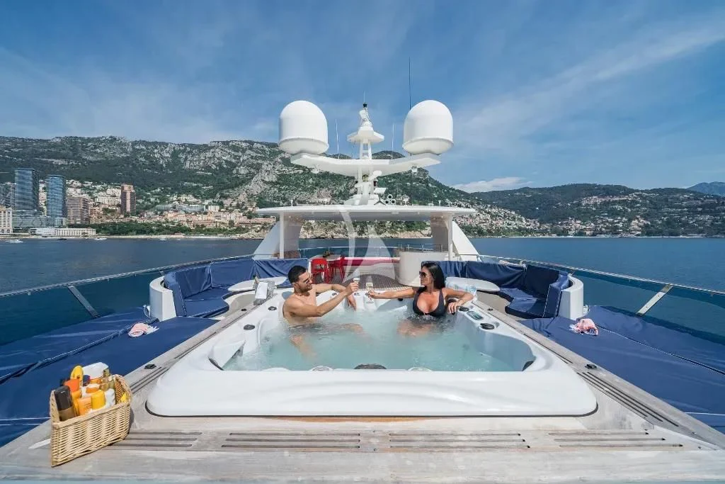 a group of people in a hot tub aboard IRAMA Yacht for Sale