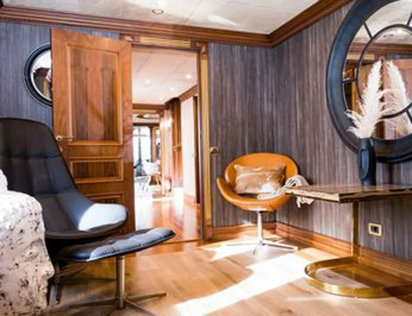a room with a mirror and a chair aboard IRAMA Yacht for Sale