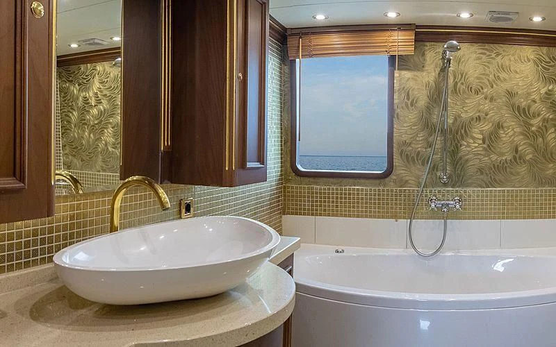 a bathroom with a sink and bathtub aboard IRAMA Yacht for Sale