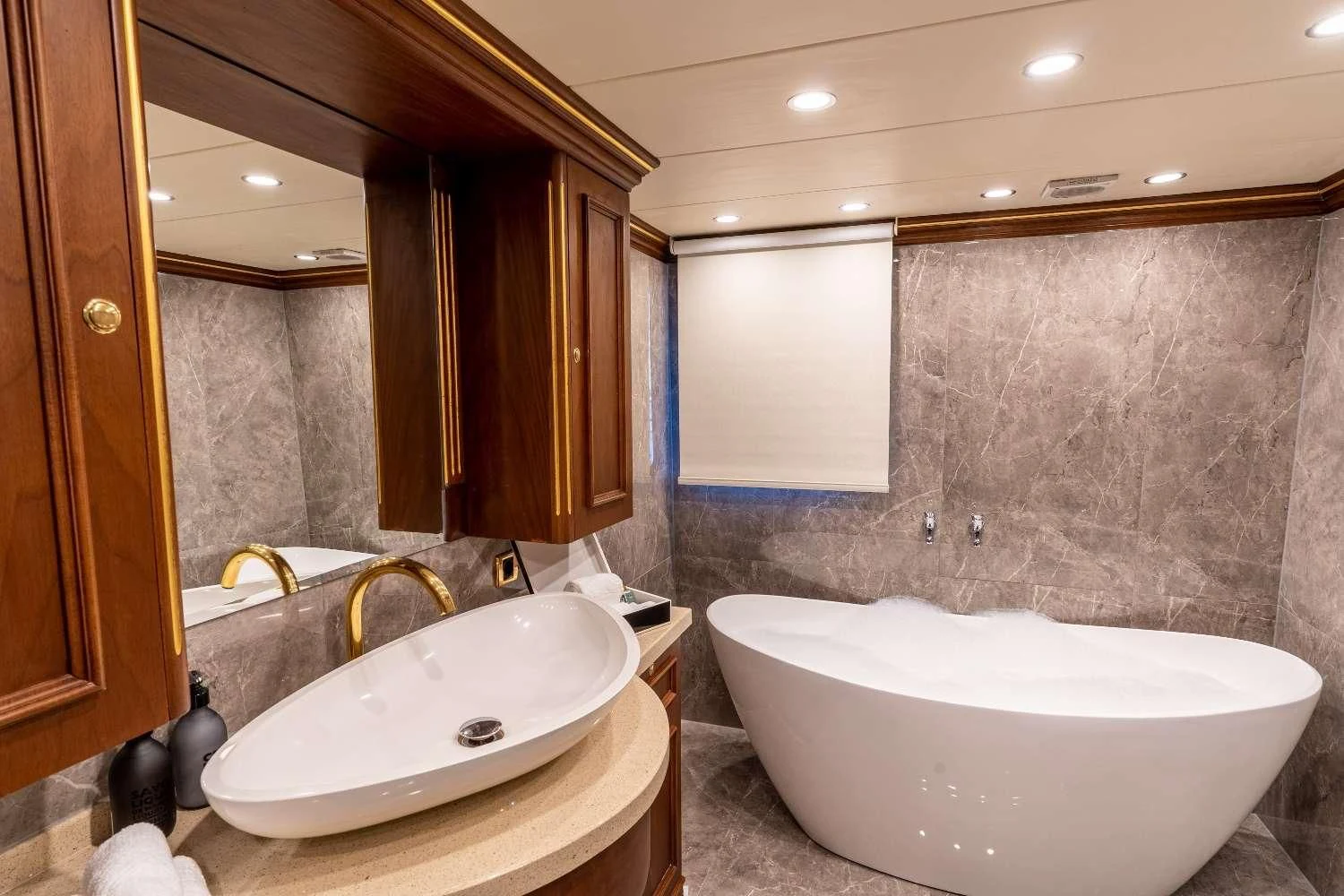a bathroom with a bathtub and sink aboard IRAMA Yacht for Sale