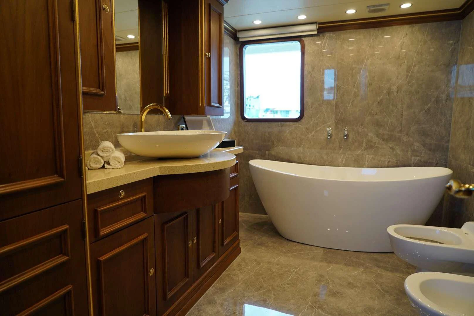 a bathroom with a tub sink and a sink aboard IRAMA Yacht for Sale