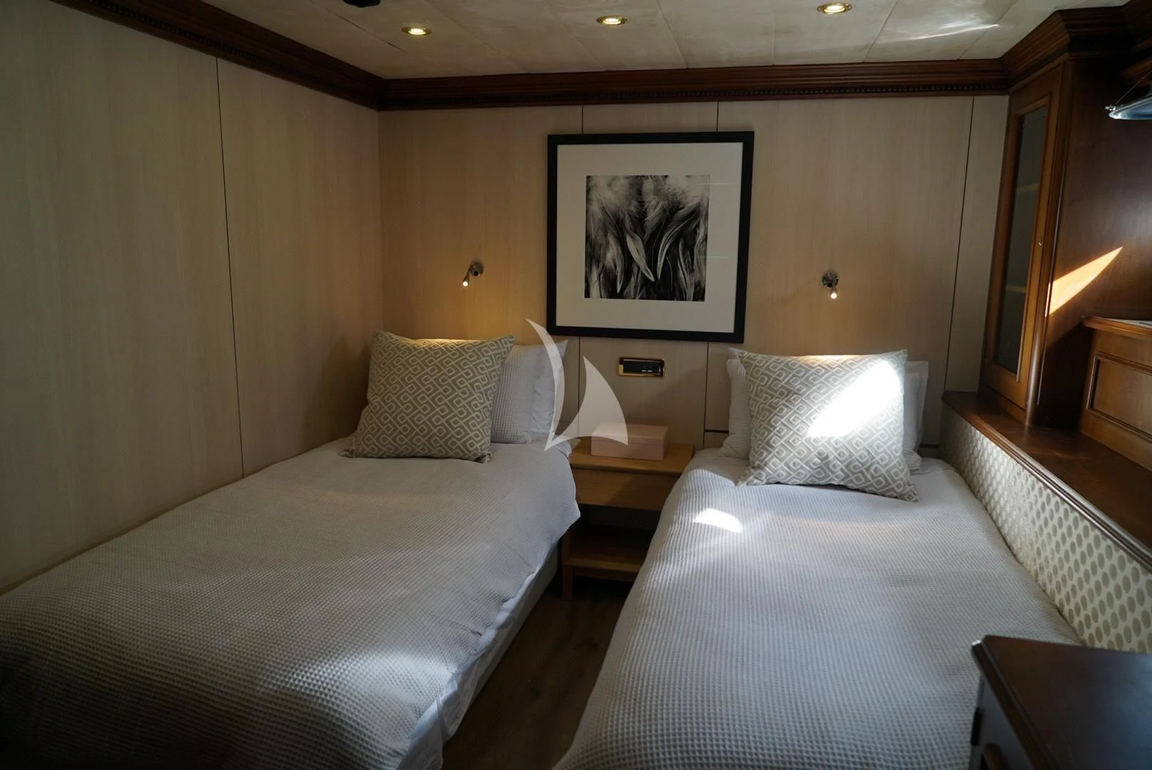 a hotel room with two beds aboard IRAMA Yacht for Sale