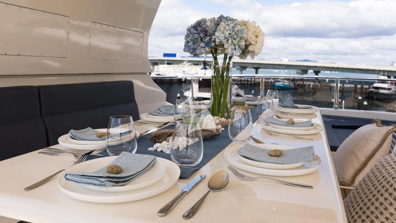 a table with plates and glasses on it aboard IRAMA Yacht for Sale
