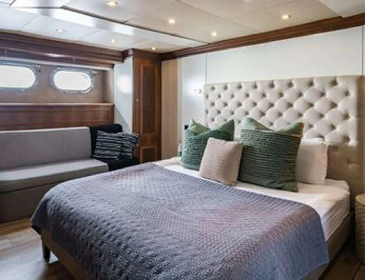 a room with a bed and a couch aboard IRAMA Yacht for Sale