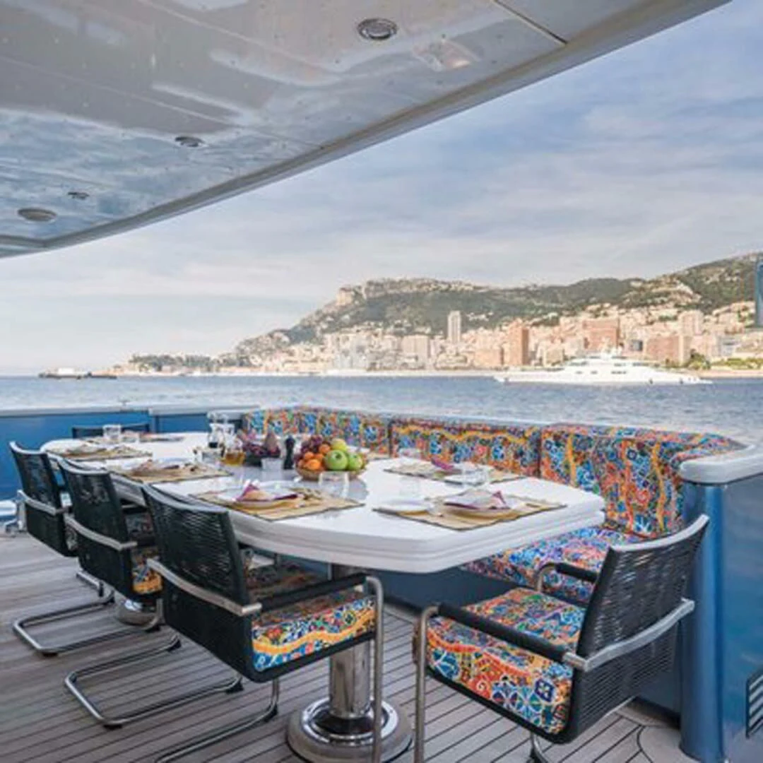 a table with food on it by a body of water aboard IRAMA Yacht for Sale